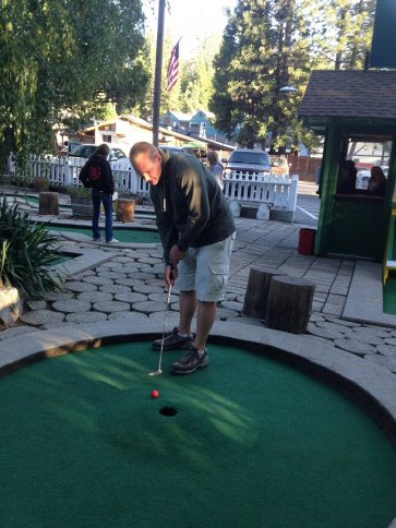 Sean lining up a putt on hole four at Twain Harte Miniature Golf.